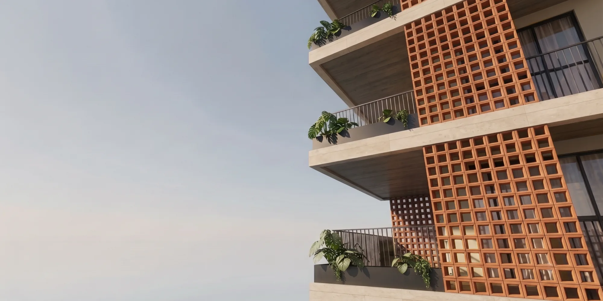 Fachada em concreto com painéis de cobogó em terracota e vegetação nas varandas
